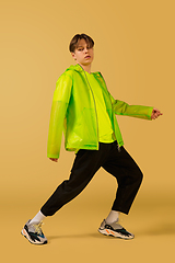 Image showing Old-school fashioned young man dancing isolated on yellow background