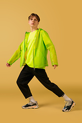 Image showing Old-school fashioned young man dancing isolated on yellow background