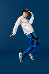 Image showing Old-school fashioned young man dancing isolated on blue background