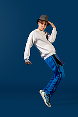 Image showing Old-school fashioned young man dancing isolated on blue background