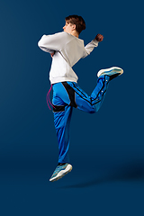 Image showing Old-school fashioned young man dancing isolated on blue background