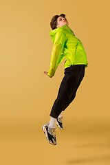 Image showing Old-school fashioned young man dancing isolated on yellow background