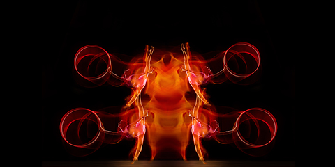 Image showing Little flexible girl isolated on black studio background. Fire flames, reflection, strobe light effect