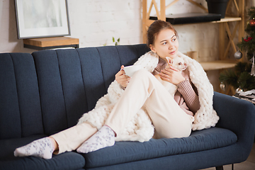 Image showing Young woman enjoying her domestic life. Home comfort, winter and holidays time