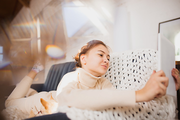 Image showing Young woman enjoying her domestic life. Home comfort, winter and holidays time