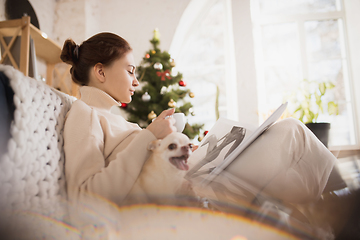 Image showing Young woman enjoying her domestic life. Home comfort, winter and holidays time