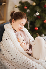 Image showing Young woman enjoying her domestic life. Home comfort, winter and holidays time