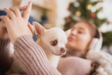 Image showing Young woman enjoying her domestic life. Home comfort, winter and holidays time