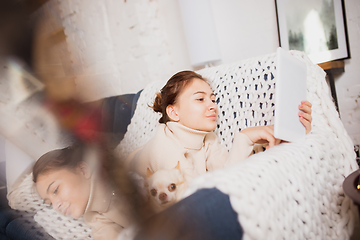 Image showing Young woman enjoying her domestic life. Home comfort, winter and holidays time