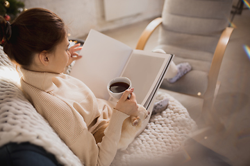 Image showing Young woman enjoying her domestic life. Home comfort, winter and holidays time