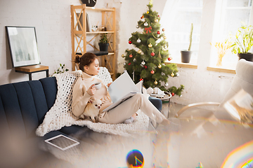 Image showing Young woman enjoying her domestic life. Home comfort, winter and holidays time