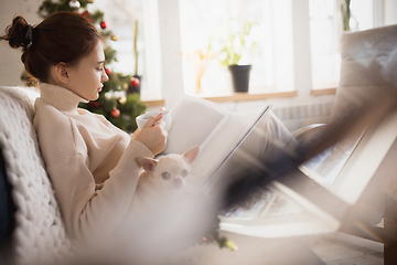 Image showing Young woman enjoying her domestic life. Home comfort, winter and holidays time