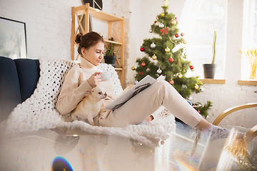 Image showing Young woman enjoying her domestic life. Home comfort, winter and holidays time