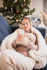 Image showing Young woman enjoying her domestic life. Home comfort, winter and holidays time