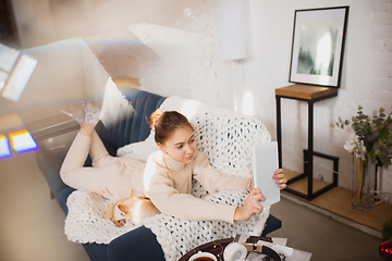 Image showing Young woman enjoying her domestic life. Home comfort, winter and holidays time