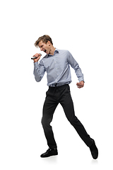 Image showing Happy young man dancing in casual clothes or suit, remaking legendary moves of celebrity from culture history