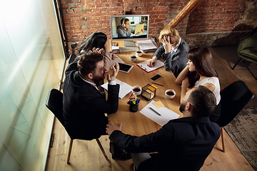 Image showing Young people talking, working during videoconference with colleagues at office or living room