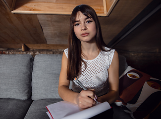 Image showing Young woman talking, working during videoconference with colleagues at home office