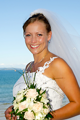 Image showing Happy smiling wedding bride with bouquet.