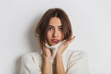 Image showing Portrait of beautiful woman isolated on white studio background. Comfort, warm in winter concept