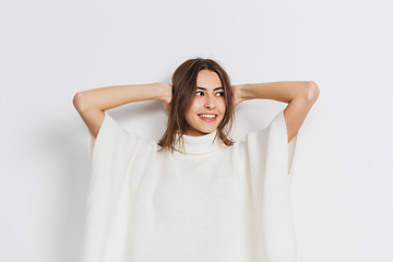 Image showing Portrait of beautiful woman isolated on white studio background. Comfort, warm in winter concept