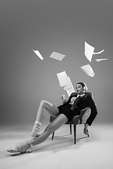 Image showing Young fashionable, stylish woman wearing jacket and socks working from home. Fashion during insulation \'cause of coronavirus pandemic