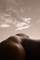 Image showing Detailed texture of human skin. Close up shot of young african-american male body like landscape with the sky background