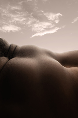 Image showing Detailed texture of human skin. Close up shot of young african-american male body like landscape with the sky background