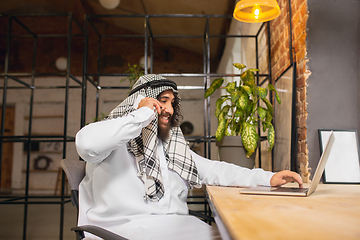 Image showing Arabian businessman working in office, business centre using devicesm gadgets. Lifestyle