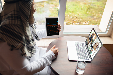 Image showing Arabian businessman working in office, business centre using devicesm gadgets. Lifestyle