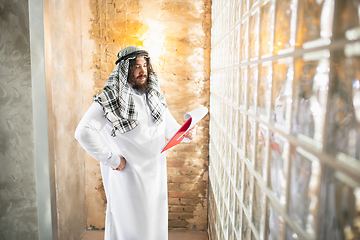 Image showing Arabian businessman working in office, business centre using devicesm gadgets. Lifestyle