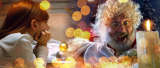 Image showing Happy caucasian little girl during video call or messaging with Santa using laptop and home devices, celebration or ad flyer with copyspace