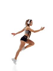 Image showing Caucasian professional female runner, athlete training isolated on white studio background. Copyspace for ad.