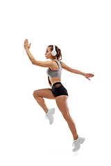 Image showing Caucasian professional female runner, athlete training isolated on white studio background. Copyspace for ad.