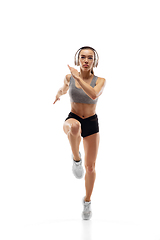 Image showing Caucasian professional female runner, athlete training isolated on white studio background. Copyspace for ad.