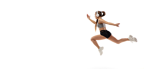 Image showing Caucasian professional female runner, athlete training isolated on white studio background. Copyspace for ad.