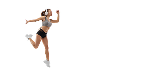 Image showing Caucasian professional female runner, athlete training isolated on white studio background. Copyspace for ad.