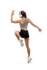 Image showing Caucasian professional female runner, athlete training isolated on white studio background. Copyspace for ad.