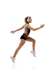 Image showing Caucasian professional female runner, athlete training isolated on white studio background. Copyspace for ad.