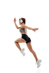 Image showing Caucasian professional female runner, athlete training isolated on white studio background. Copyspace for ad.