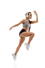 Image showing Caucasian professional female runner, athlete training isolated on white studio background. Copyspace for ad.