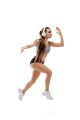 Image showing Caucasian professional female runner, athlete training isolated on white studio background. Copyspace for ad.