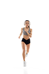 Image showing Caucasian professional female runner, athlete training isolated on white studio background. Copyspace for ad.