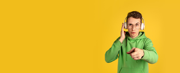 Image showing Portrait of young caucasian man isolated on yellow studio background