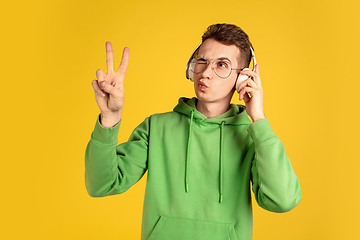 Image showing Portrait of young caucasian man isolated on yellow studio background