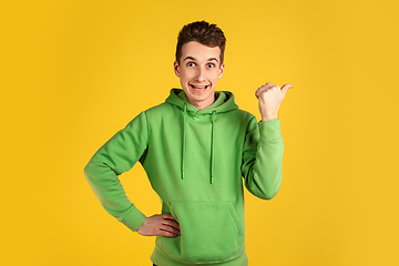Image showing Portrait of young caucasian man isolated on yellow studio background