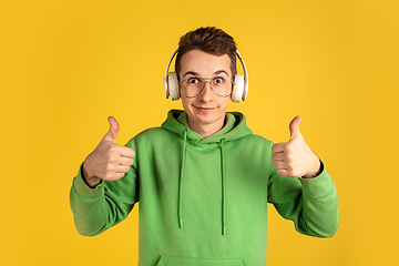 Image showing Portrait of young caucasian man isolated on yellow studio background