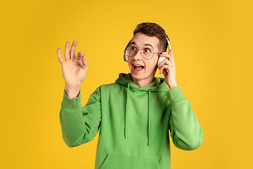 Image showing Portrait of young caucasian man isolated on yellow studio background