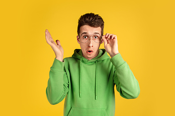 Image showing Portrait of young caucasian man isolated on yellow studio background