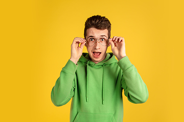 Image showing Portrait of young caucasian man isolated on yellow studio background